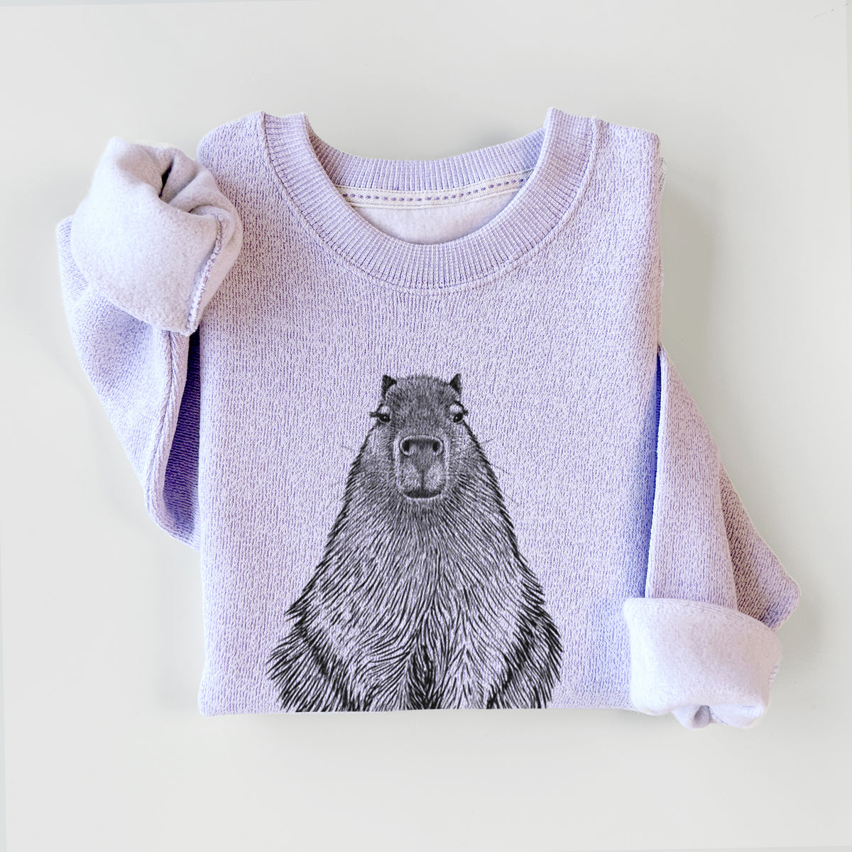 Ice purple knit sweatshirt printed with a detailed black ink illustration of a capybara sitting and facing forward, styled flat.