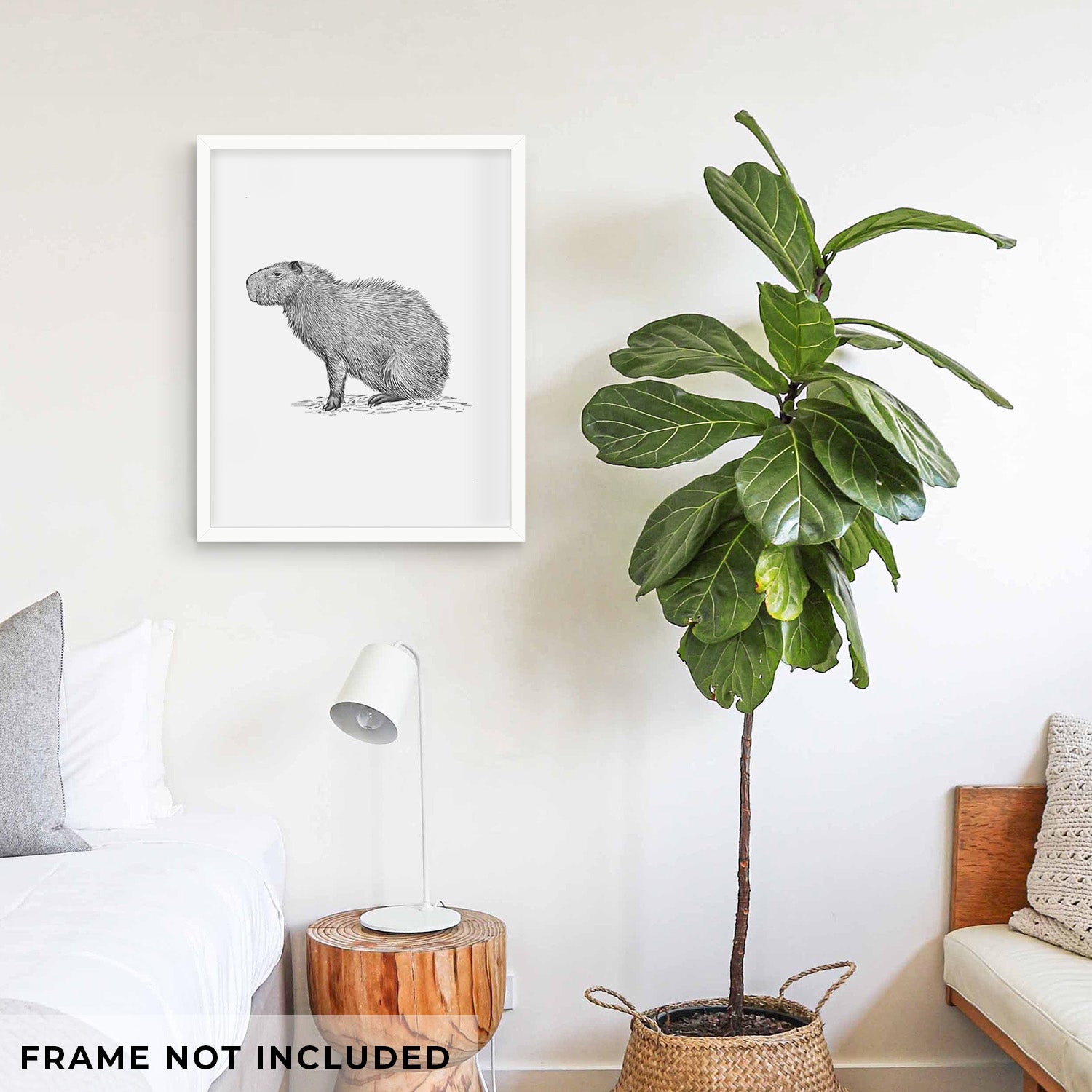 Art print of a detailed black ink illustration of a capybara standing in profile, shown with eucalyptus leaves.