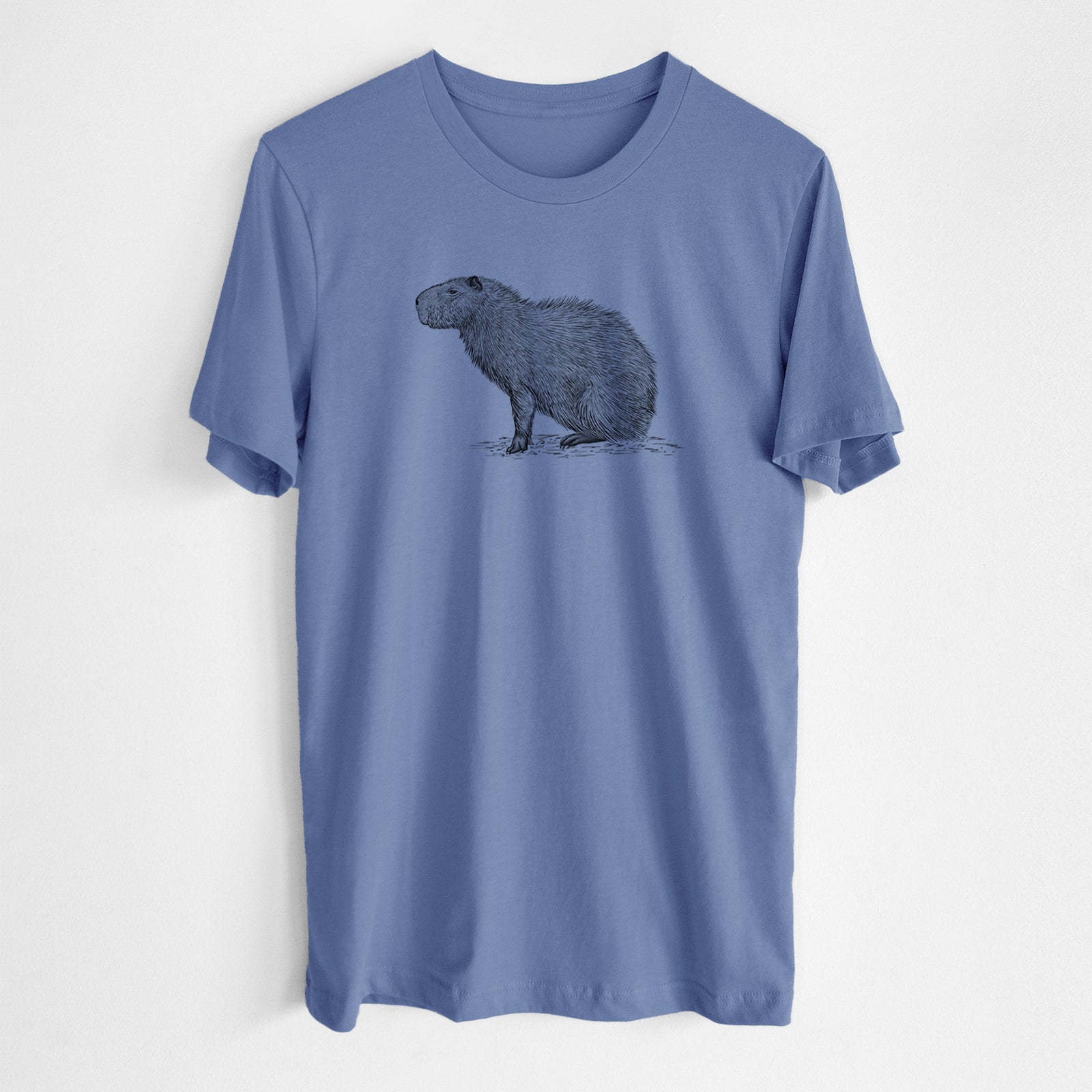 Blue bell lightweight cotton t-shirt laid flat, printed with a detailed black ink illustration of a capybara standing in profile.