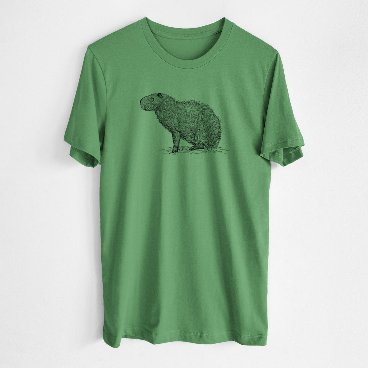 Leaf green lightweight cotton t-shirt laid flat, printed with a detailed black ink illustration of a capybara standing in profile.