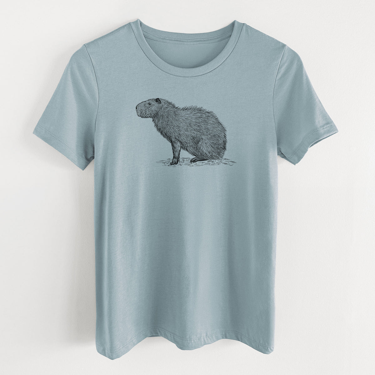 Vintage denim women's relaxed fit cotton t-shirt laid flat, printed with a detailed black ink illustration of a capybara standing in profile.