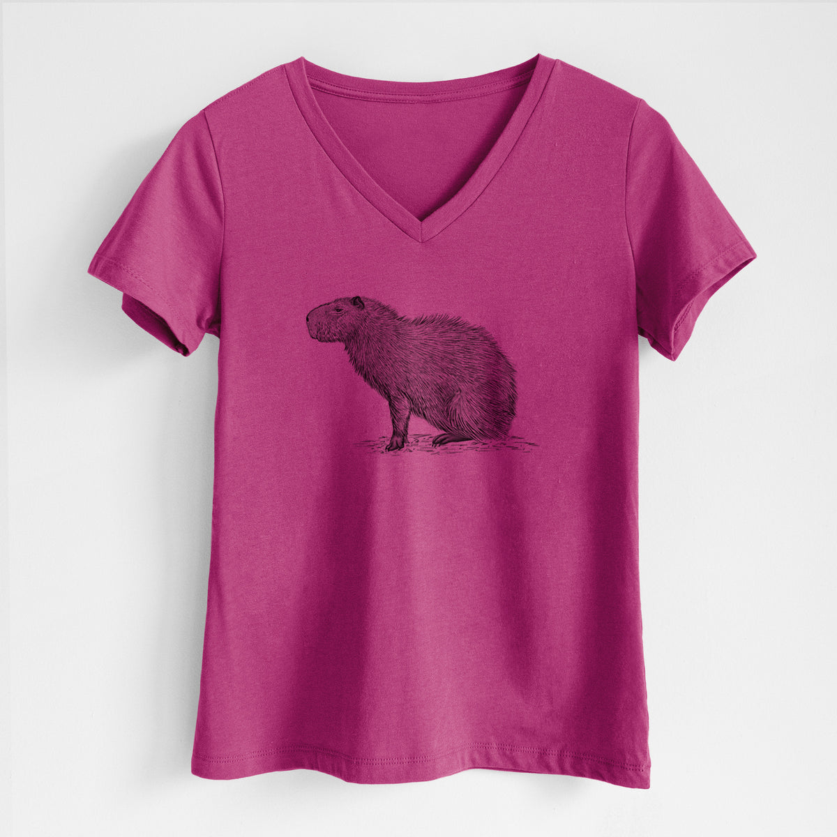 Berry pink women's relaxed fit cotton V-neck t-shirt laid flat, printed with a detailed black ink illustration of a capybara standing in profile.