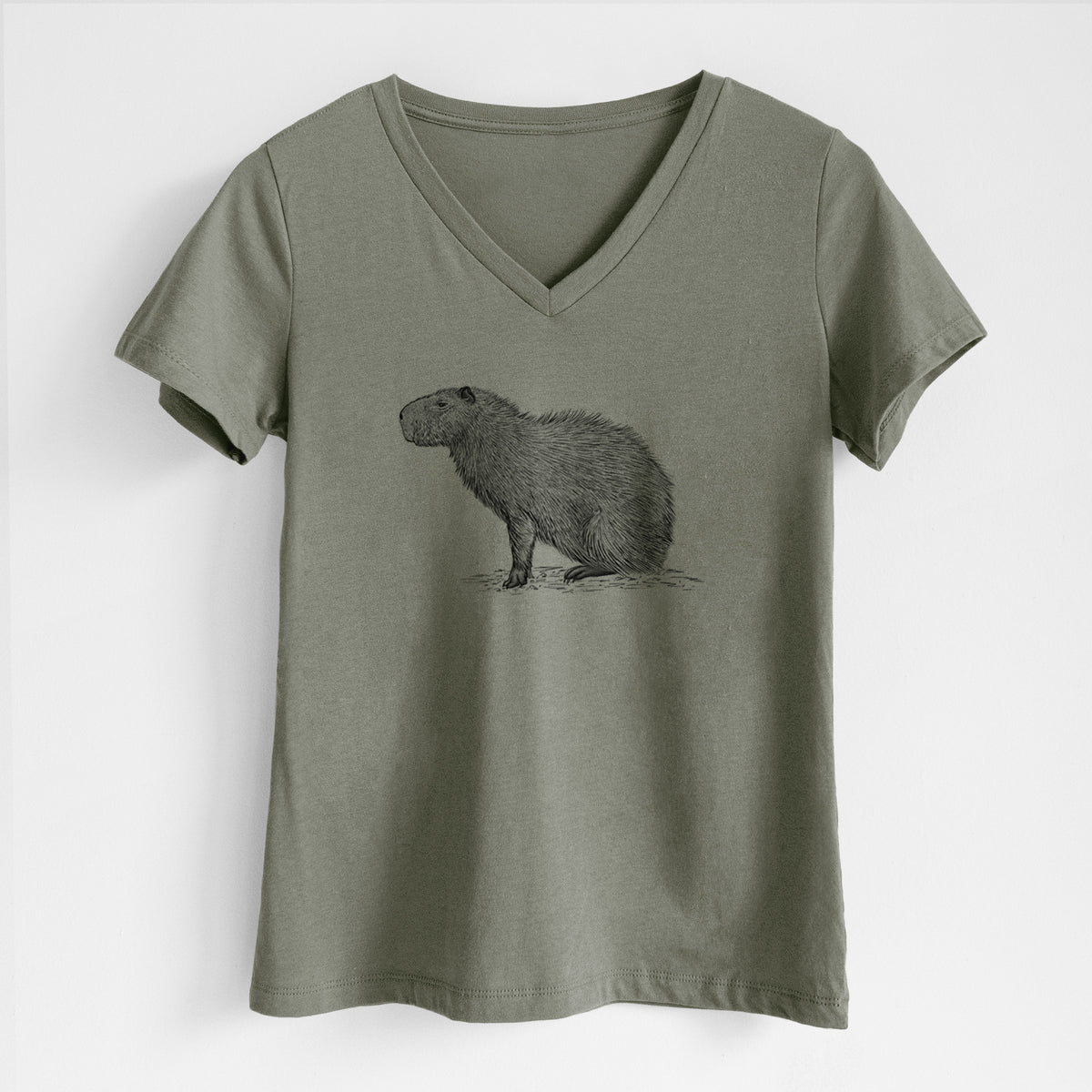 Military green women's relaxed fit cotton V-neck t-shirt laid flat, printed with a detailed black ink illustration of a capybara standing in profile.