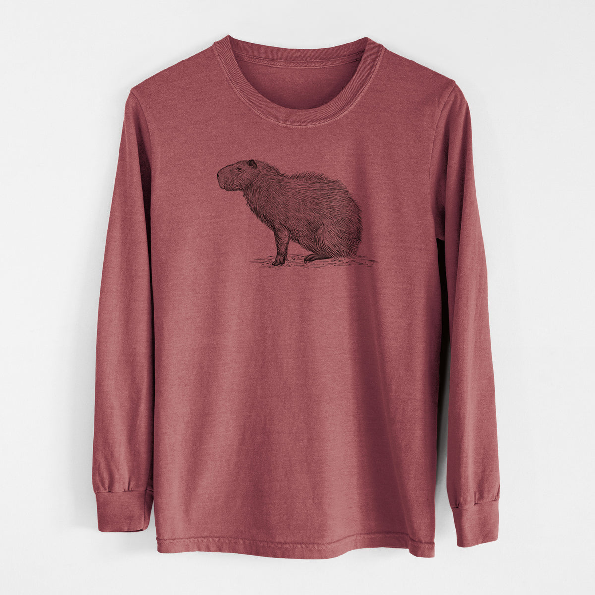 Brick red Comfort Colors long sleeve shirt laid flat, printed with a detailed black ink illustration of a capybara standing in profile.