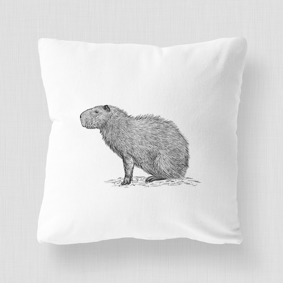 White pillow cover printed with a detailed black ink illustration of a capybara standing in profile.