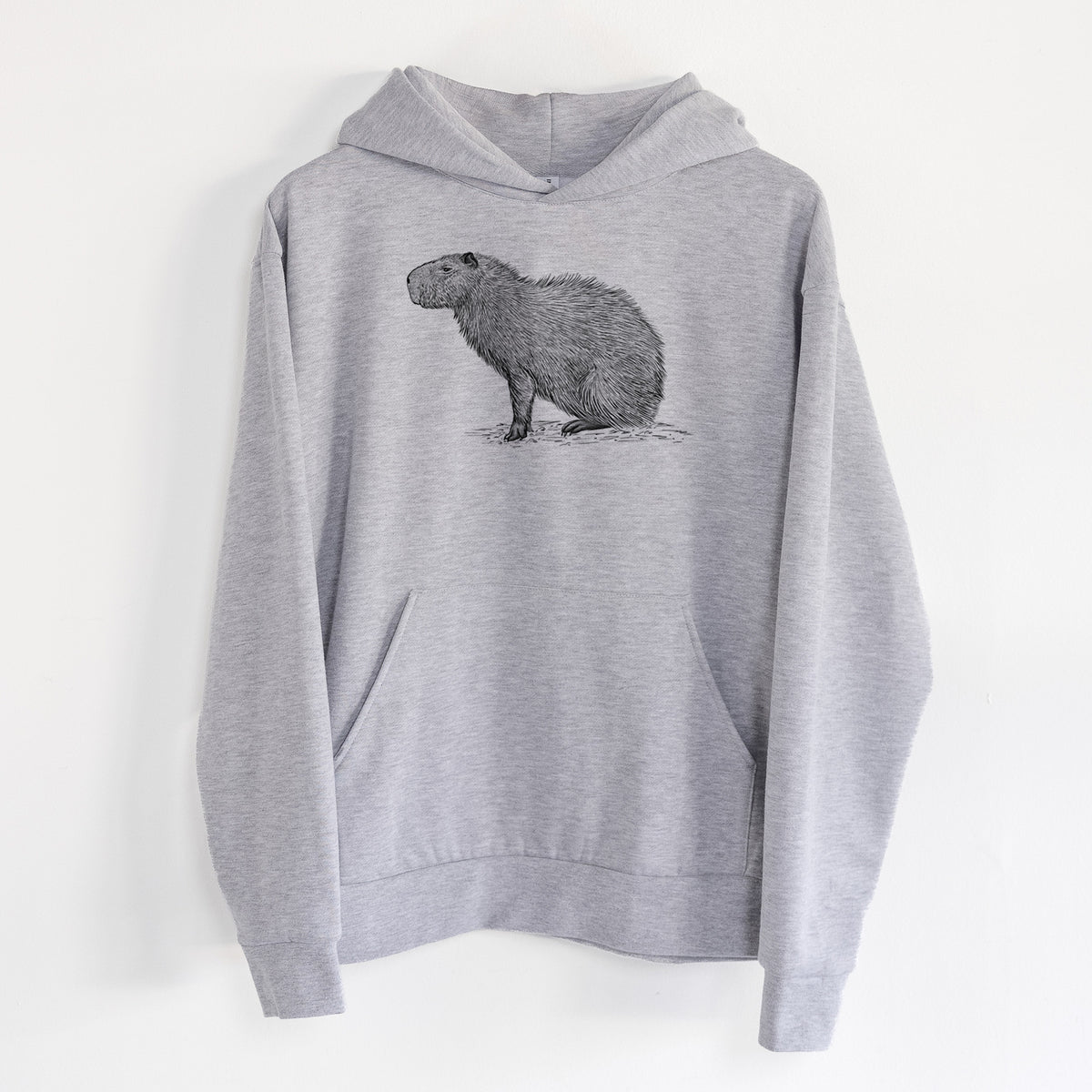 Capybara Profile - Hydrochoerus hydrochaeris - Statement Midweight Hoodie in Heather Grey, hanging on a white wall, with a front kangaroo pocket and no drawcords.
