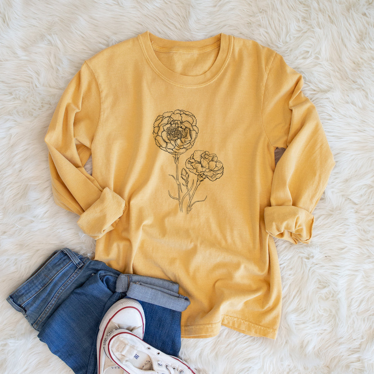Golden wheat yellow Comfort Colors long sleeve shirt printed with a black ink line drawing of carnation flowers on stems, shown in a lifestyle photo.