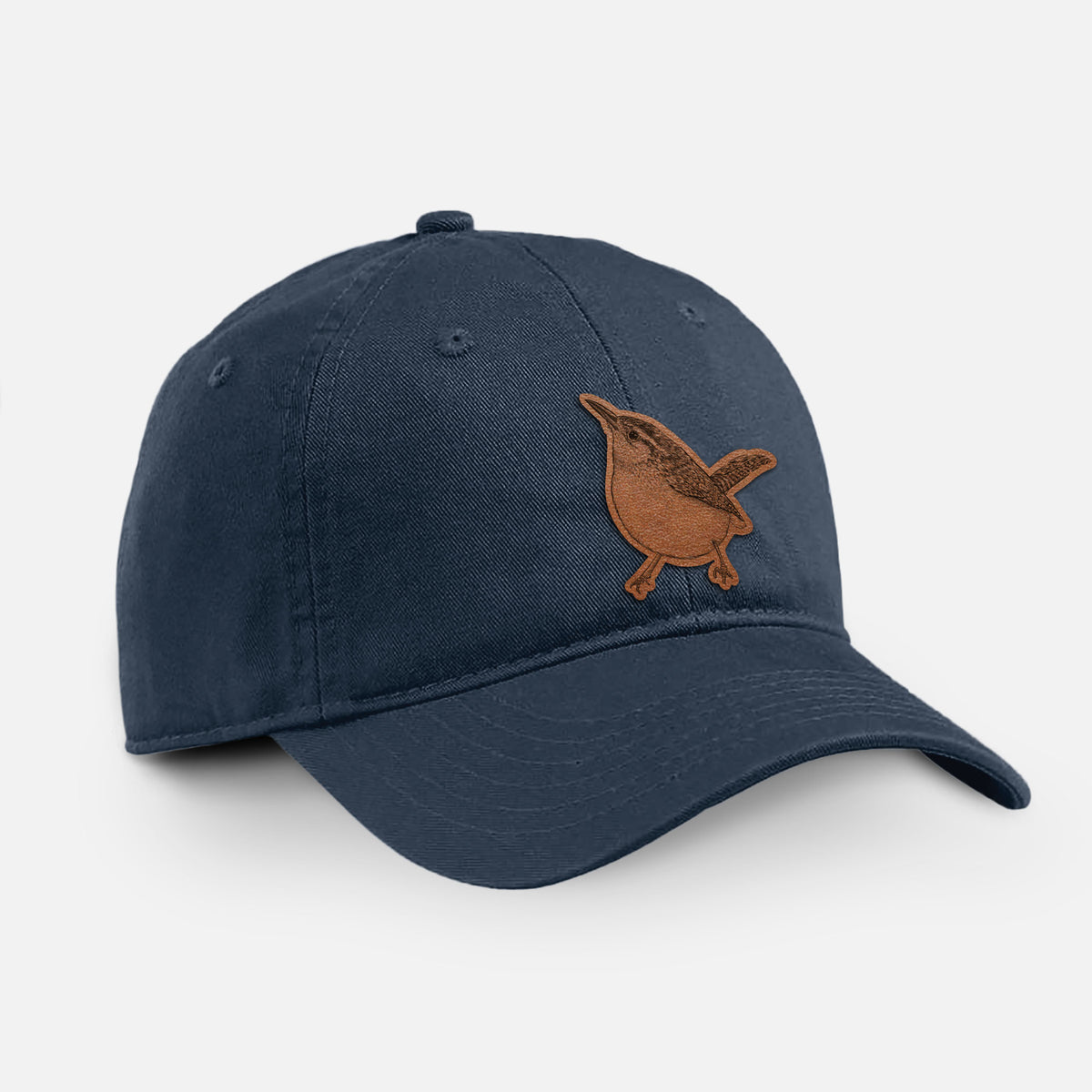 Navy cotton baseball hat with a detailed black ink sketch of a Carolina wren perched on a branch with its tail raised on the front.