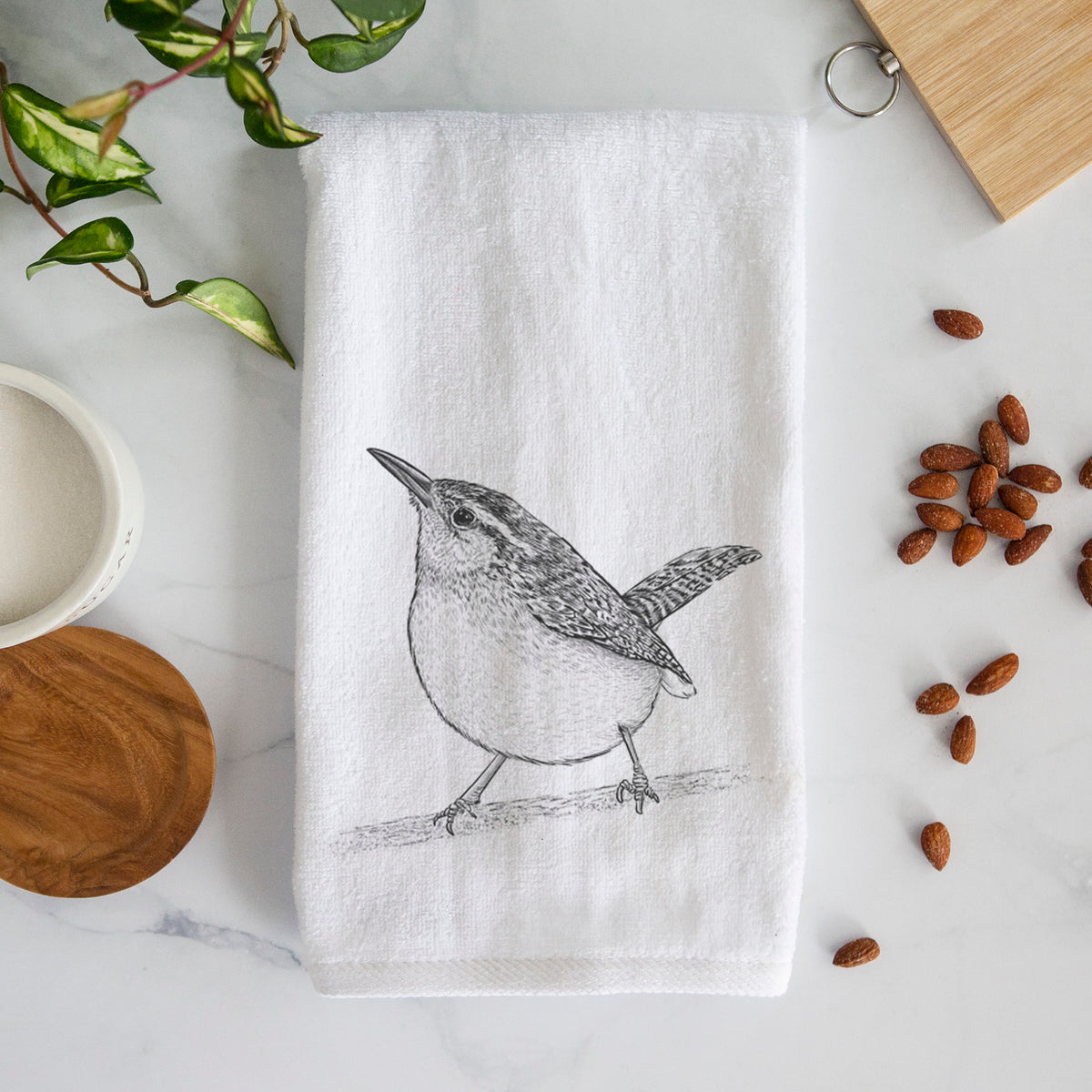 White hand towel printed with a detailed black ink sketch of a Carolina wren perched on a branch with its tail raised.
