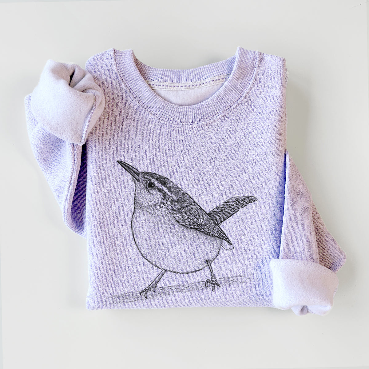 Ice purple knit sweatshirt printed with a detailed black ink sketch of a Carolina wren perched on a branch with its tail raised, styled flat.