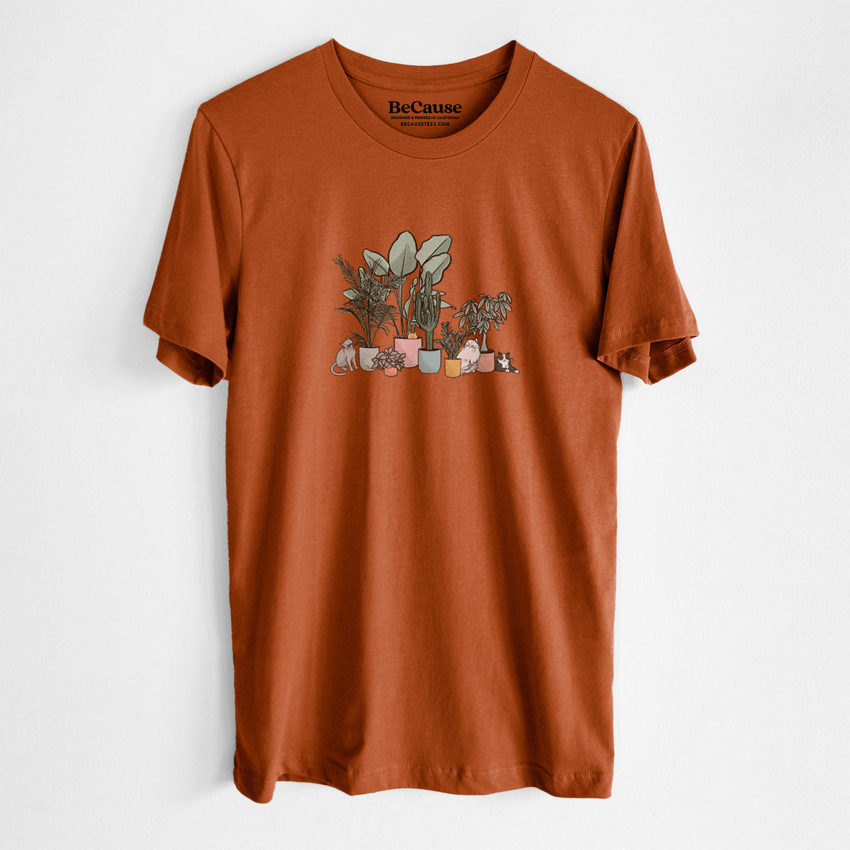 Autumn lightweight cotton t-shirt laid flat, printed with a full-color illustration of cats lounging among potted houseplants.