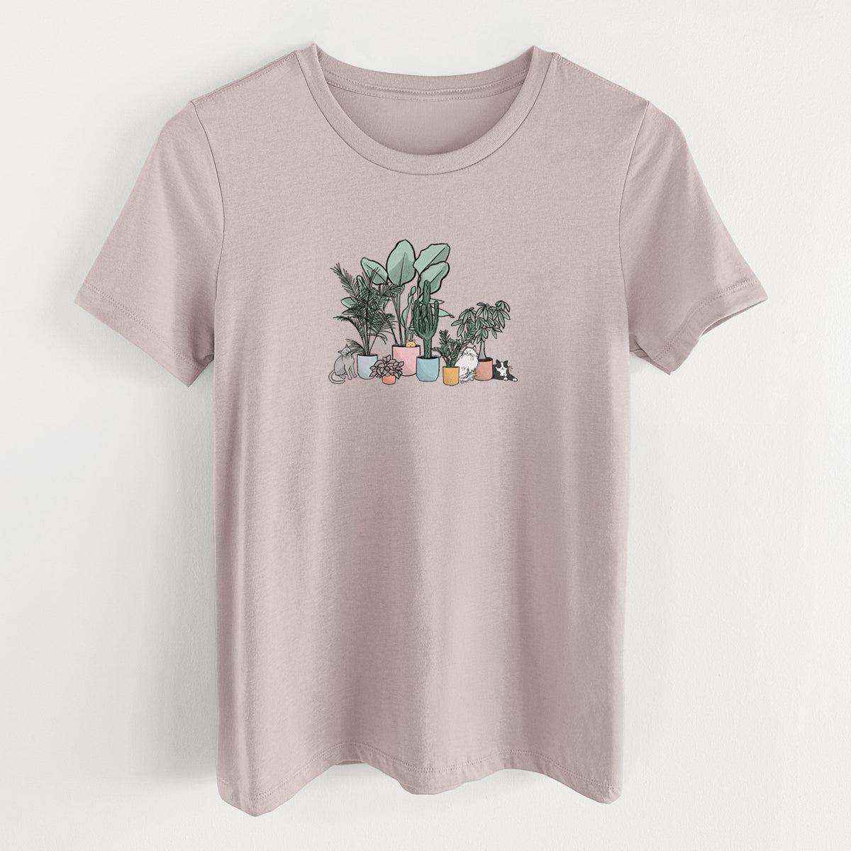 Pink gravel women's relaxed fit cotton t-shirt laid flat, printed with a full-color illustration of cats lounging among potted houseplants.