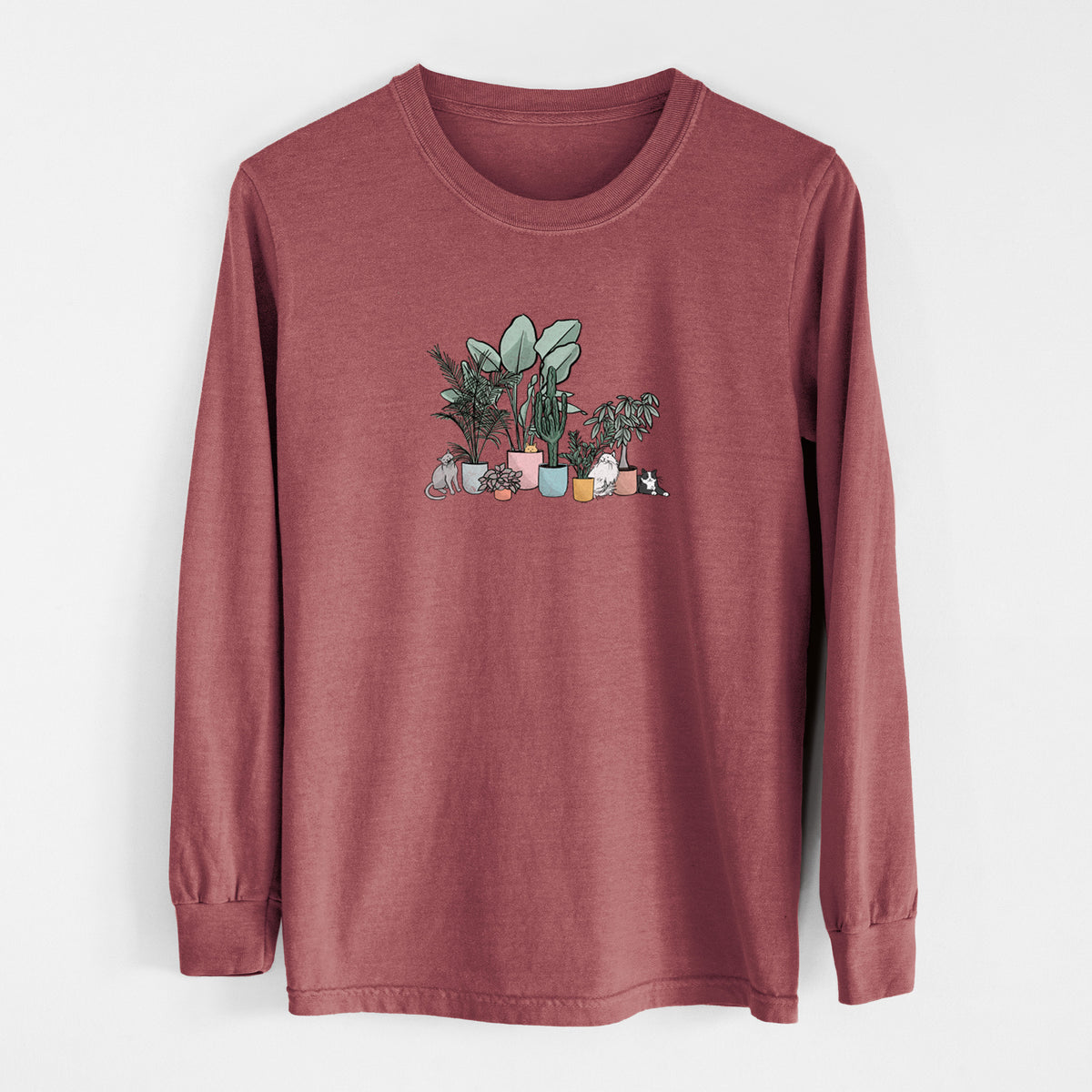 Brick red Comfort Colors long sleeve shirt laid flat, printed with a full-color illustration of cats lounging among potted houseplants.
