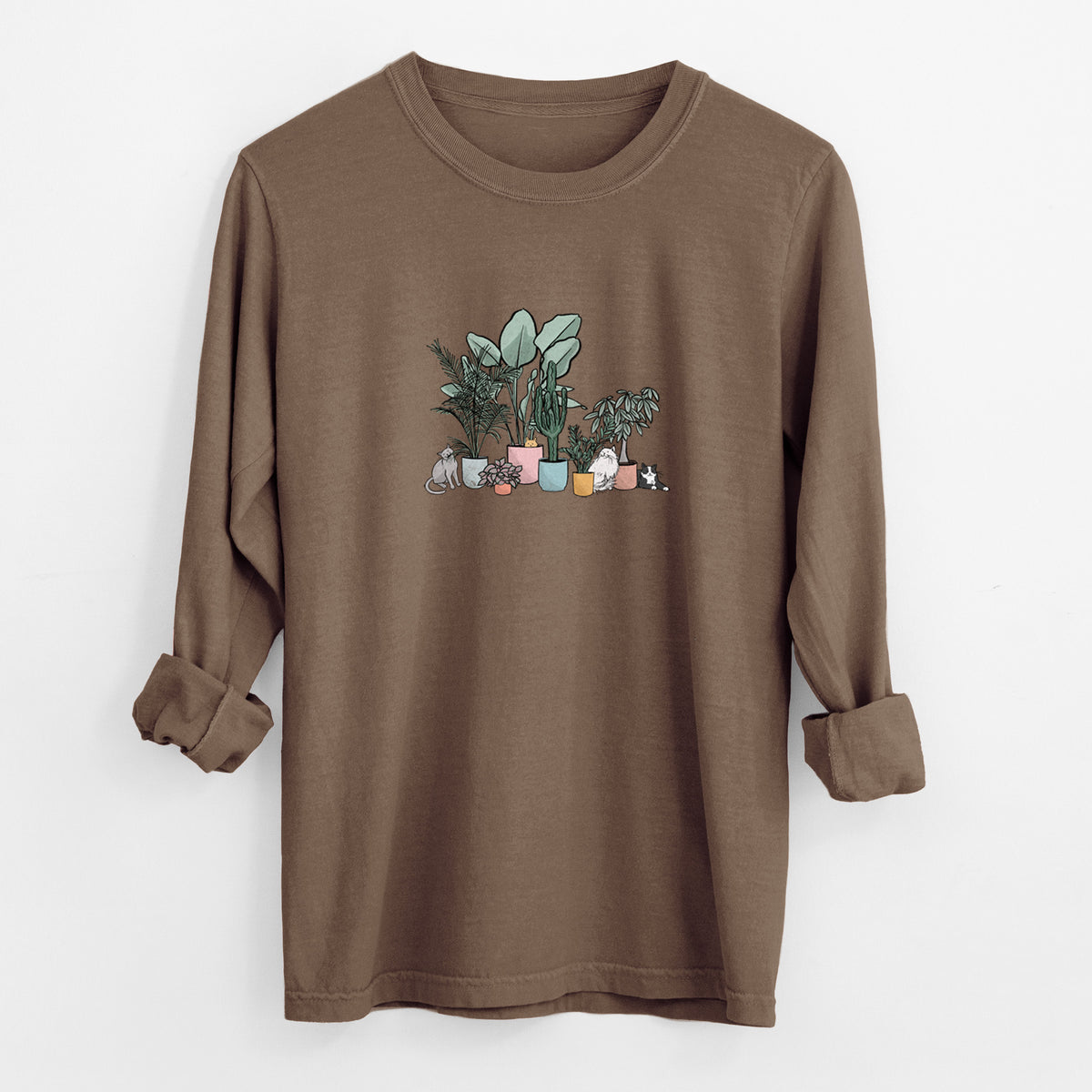 Espresso brown Comfort Colors long sleeve shirt laid flat with the cuffs rolled, printed with a full-color illustration of cats lounging among potted houseplants.