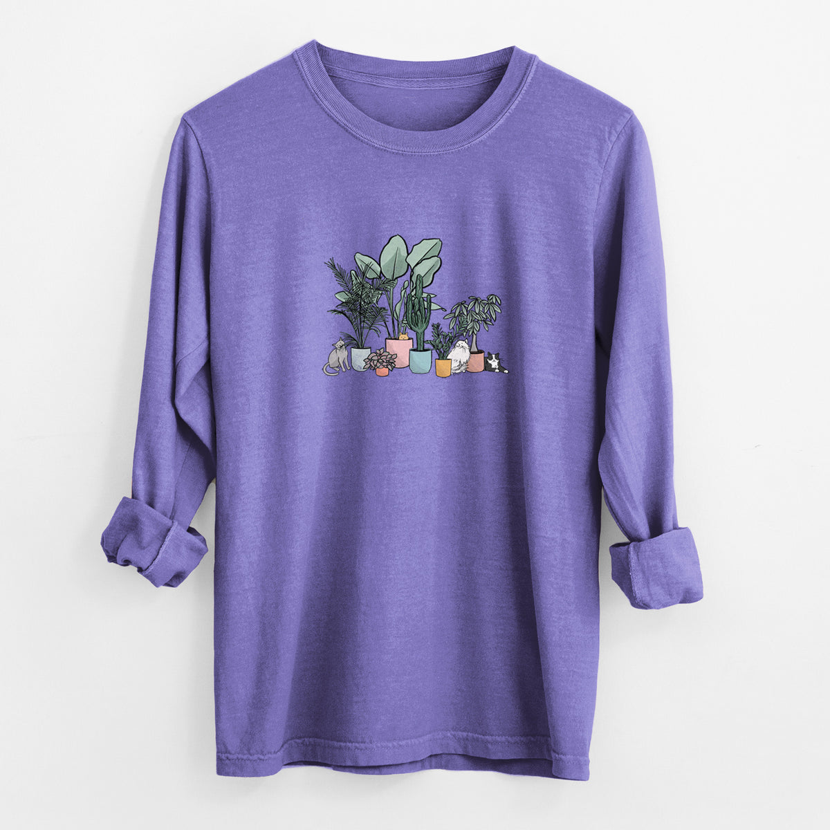 Violet purple Comfort Colors long sleeve shirt laid flat with the cuffs rolled, printed with a full-color illustration of cats lounging among potted houseplants.