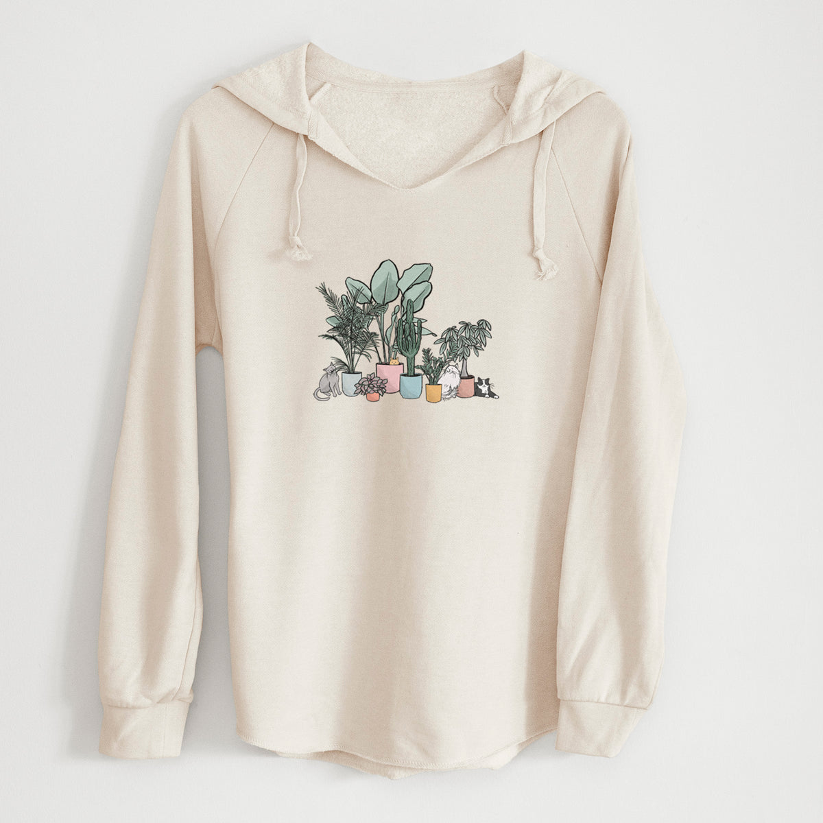 Bone cream women's Cali Wave hooded sweatshirt laid flat, printed with a full-color illustration of cats lounging among potted houseplants.