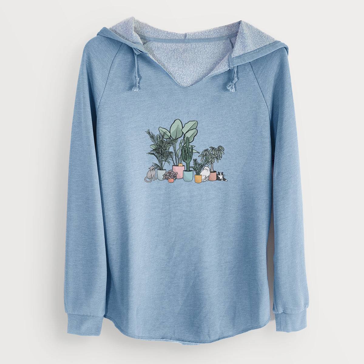 Misty blue women's Cali Wave hooded sweatshirt laid flat, printed with a full-color illustration of cats lounging among potted houseplants.