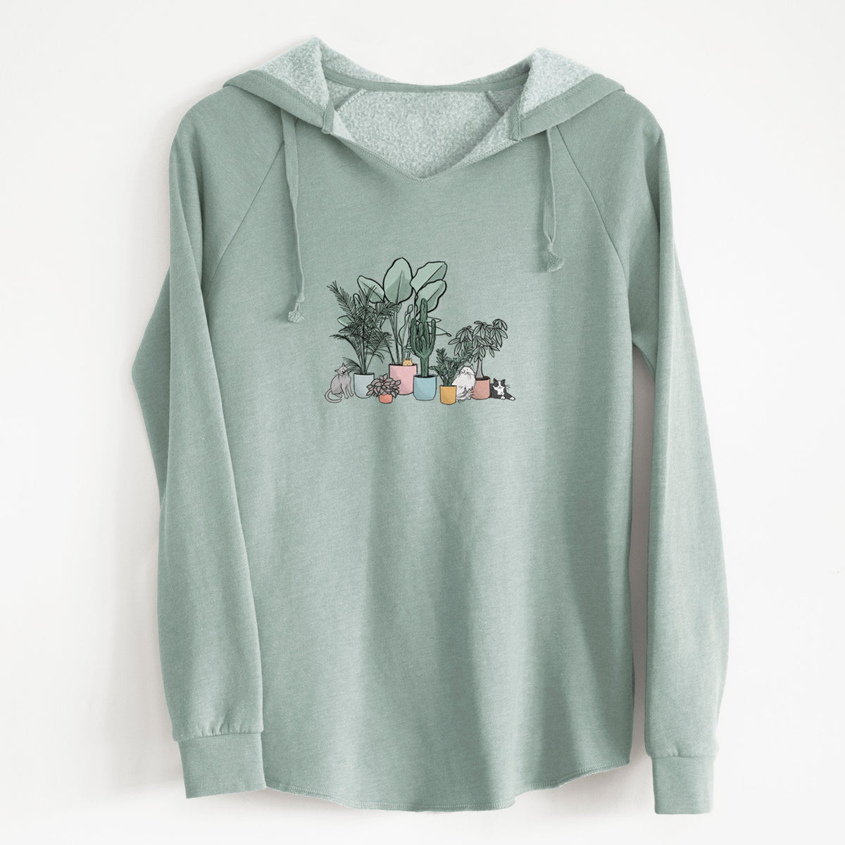 Sage green women's Cali Wave hooded sweatshirt laid flat, printed with a full-color illustration of cats lounging among potted houseplants.