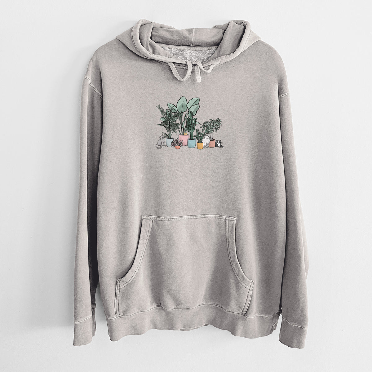 Cement grey pigment dyed hoodie laid flat, printed with a full-color illustration of cats lounging among potted houseplants.