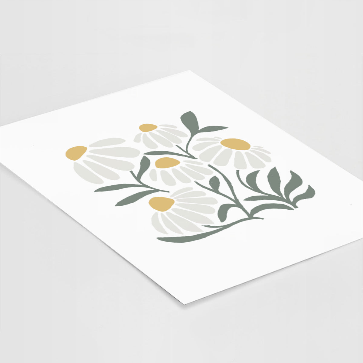 Art print of a soft full-color illustration of white chamomile flowers and green leaves, lying at an angle on a white surface.