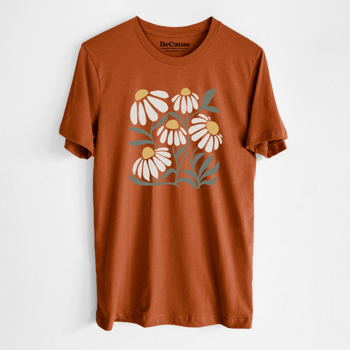 Autumn lightweight cotton t-shirt laid flat, printed with a soft full-color illustration of white chamomile flowers and green leaves.