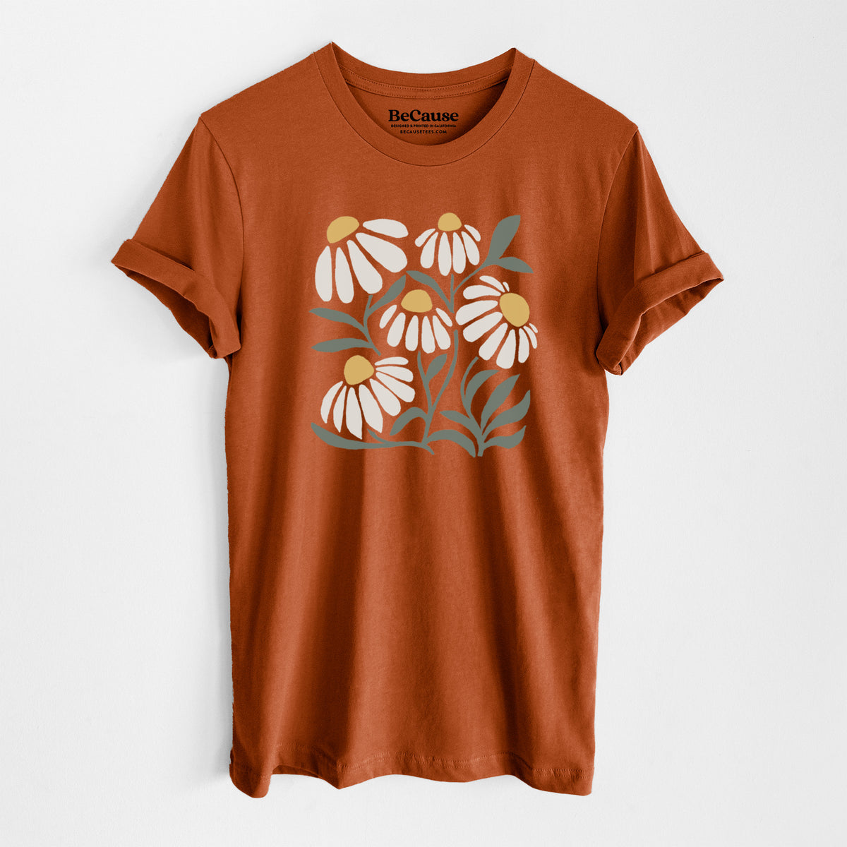 Autumn lightweight cotton t-shirt laid flat, printed with a soft full-color illustration of white chamomile flowers and green leaves.