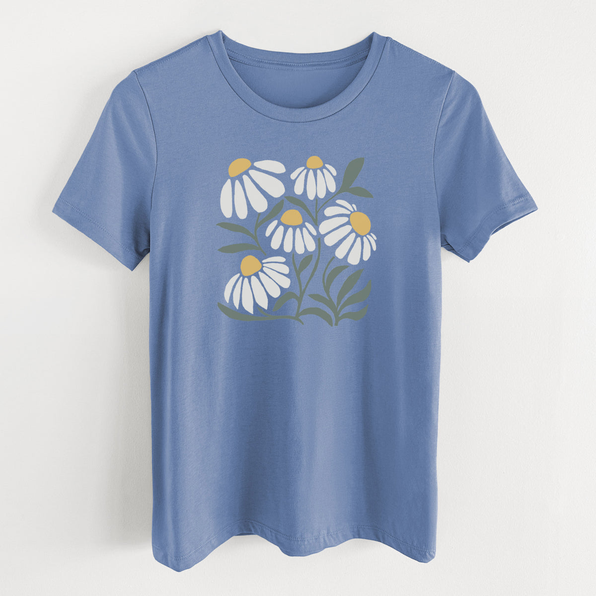 Blue bell women's relaxed fit cotton t-shirt laid flat, printed with a soft full-color illustration of white chamomile flowers and green leaves.