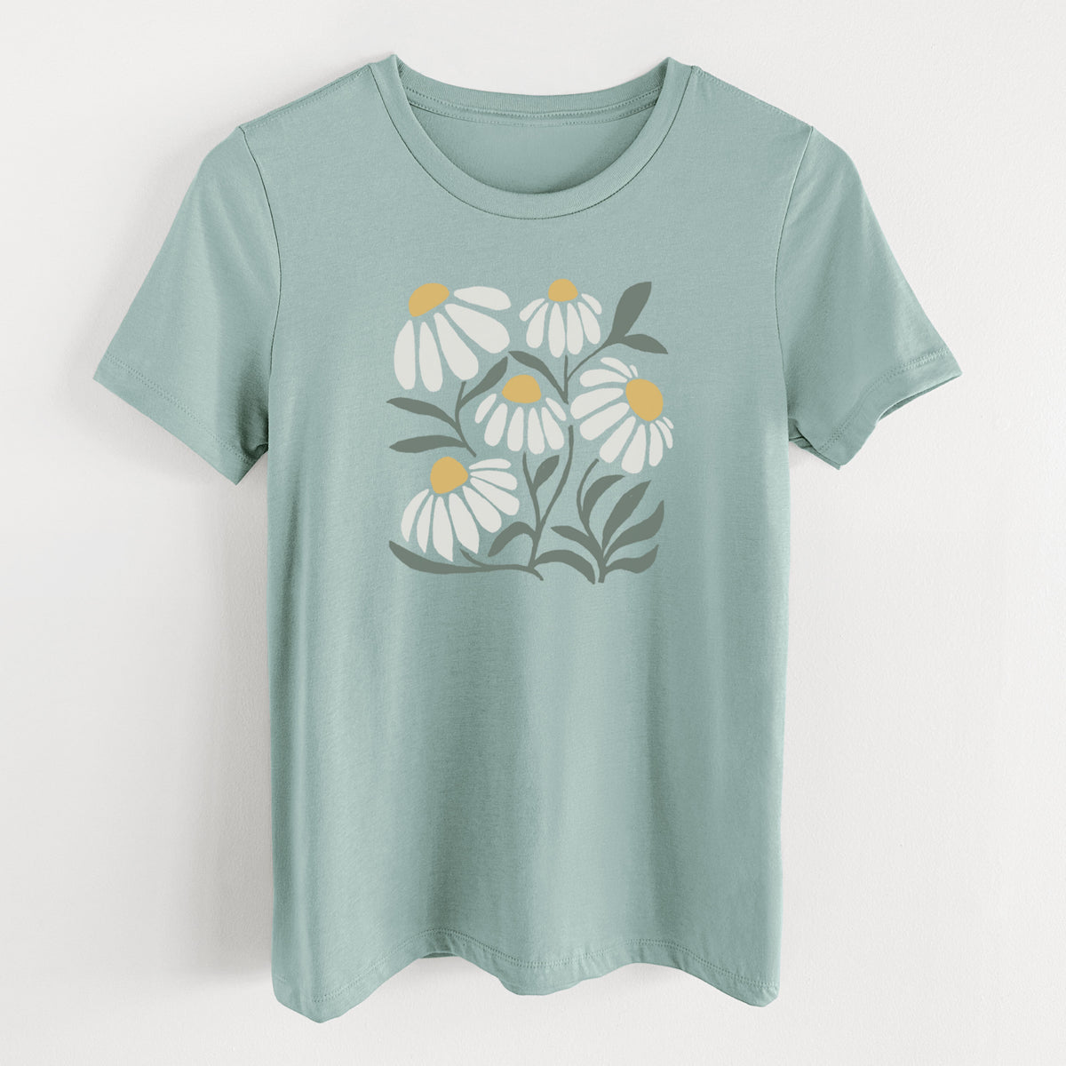 Dusty blue women's relaxed fit cotton t-shirt laid flat, printed with a soft full-color illustration of white chamomile flowers and green leaves.