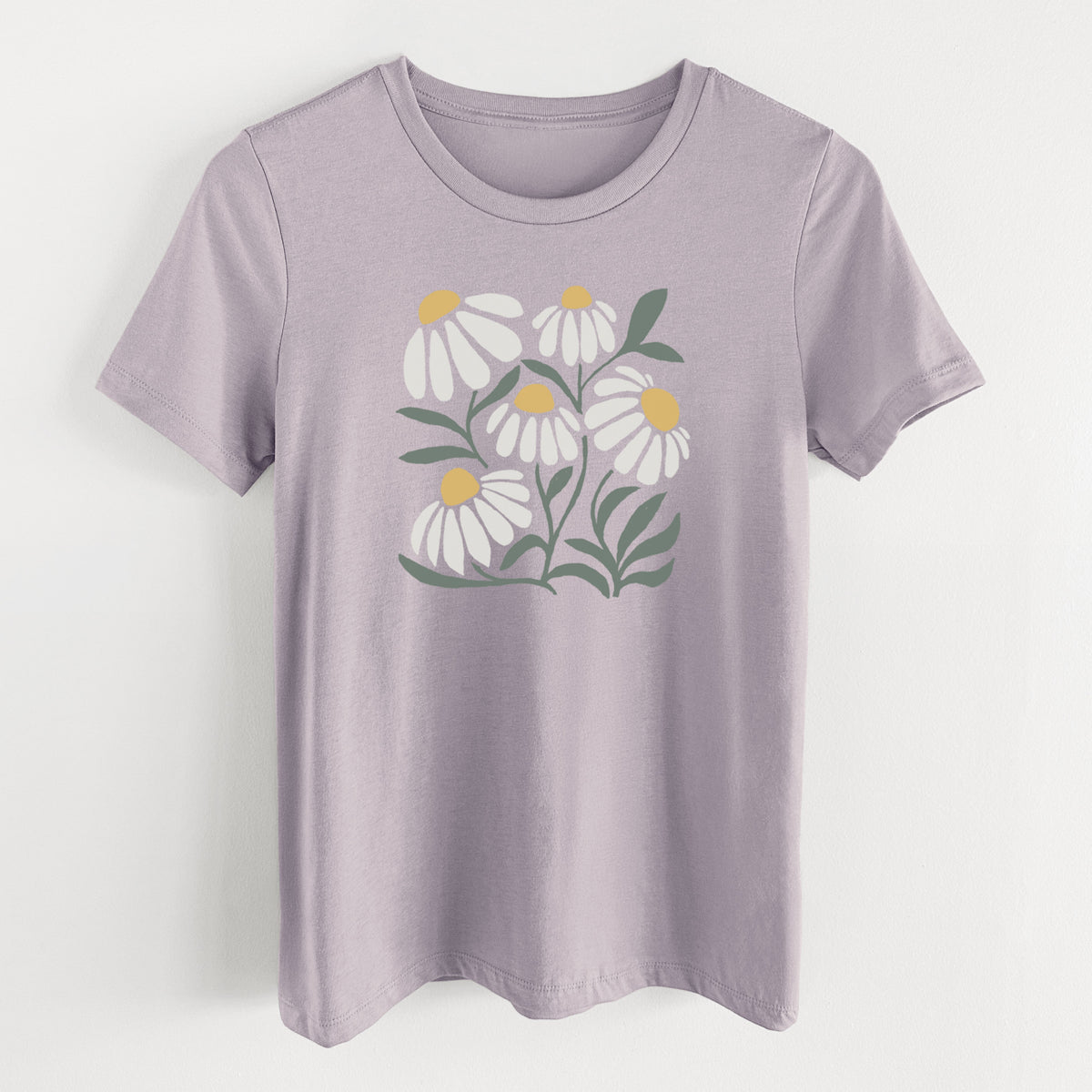 Light violet women's relaxed fit cotton t-shirt laid flat, printed with a soft full-color illustration of white chamomile flowers and green leaves.