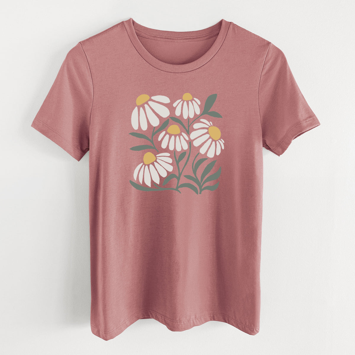 Mauve pink women's relaxed fit cotton t-shirt laid flat, printed with a soft full-color illustration of white chamomile flowers and green leaves.