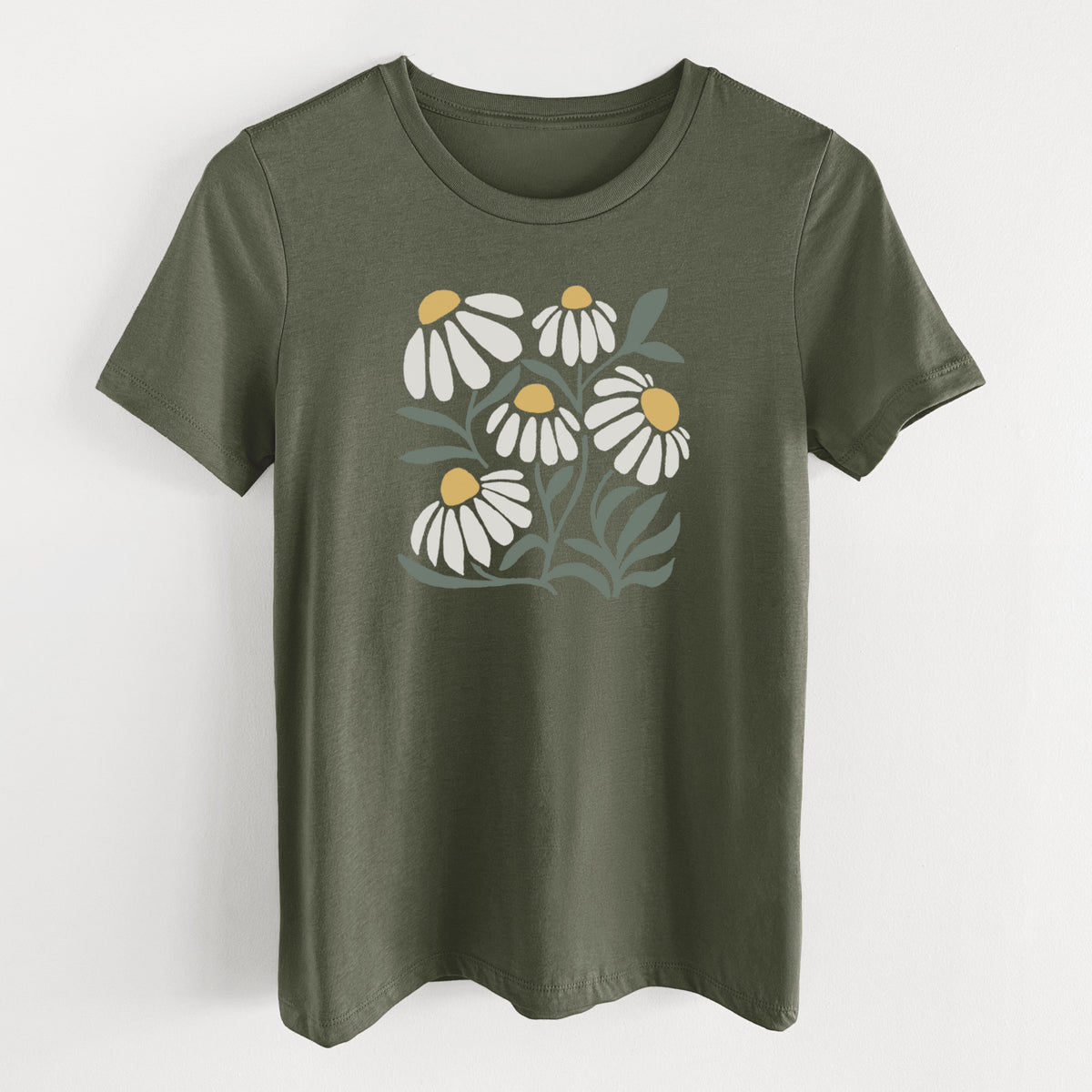 Military green women's relaxed fit cotton t-shirt laid flat, printed with a soft full-color illustration of white chamomile flowers and green leaves.