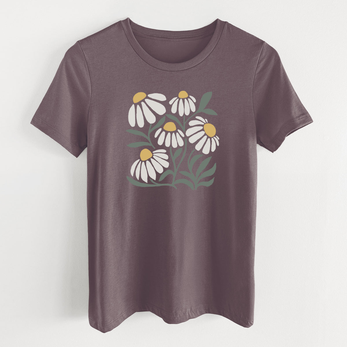 Purple storm women's relaxed fit cotton t-shirt laid flat, printed with a soft full-color illustration of white chamomile flowers and green leaves.
