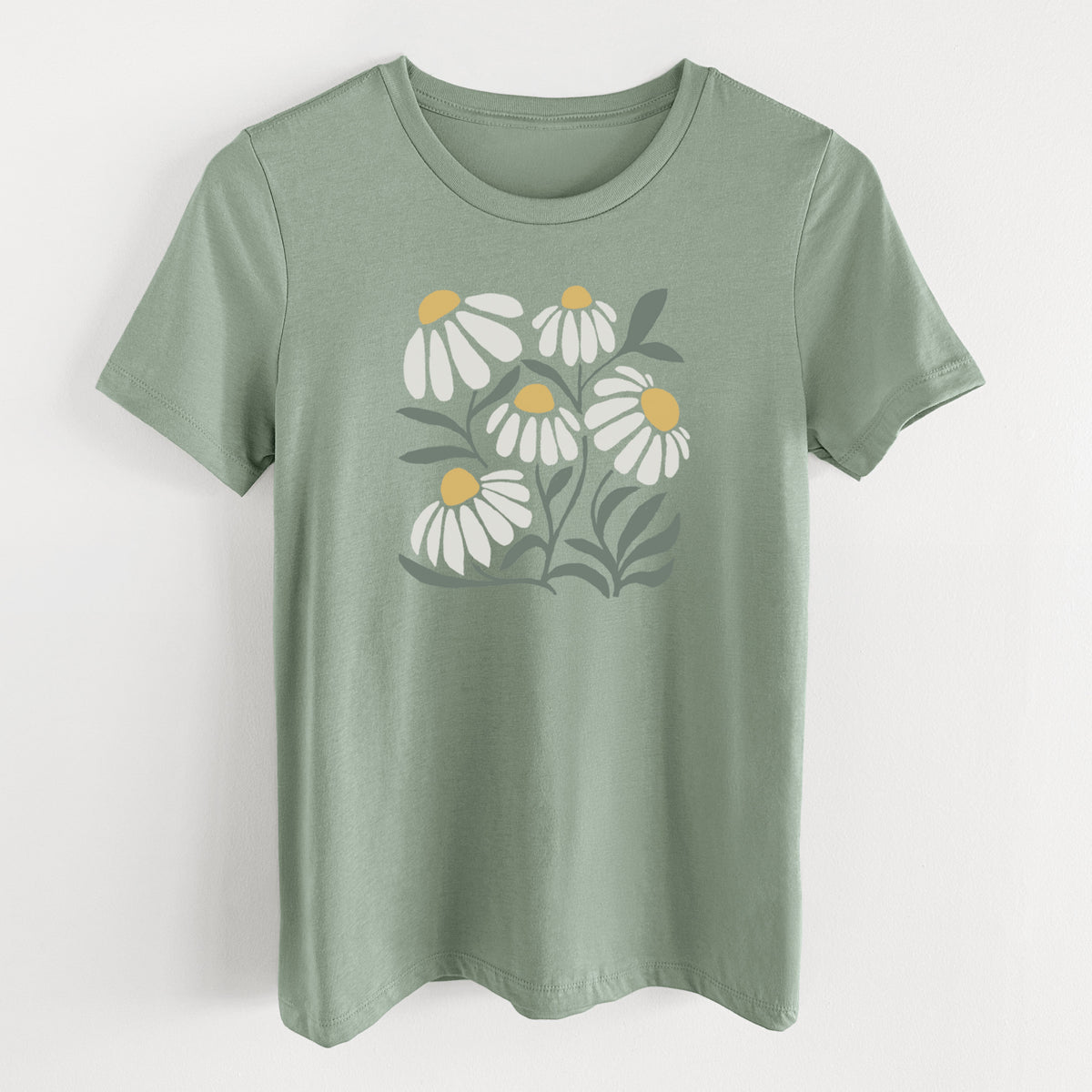 Sage green women's relaxed fit cotton t-shirt laid flat, printed with a soft full-color illustration of white chamomile flowers and green leaves.