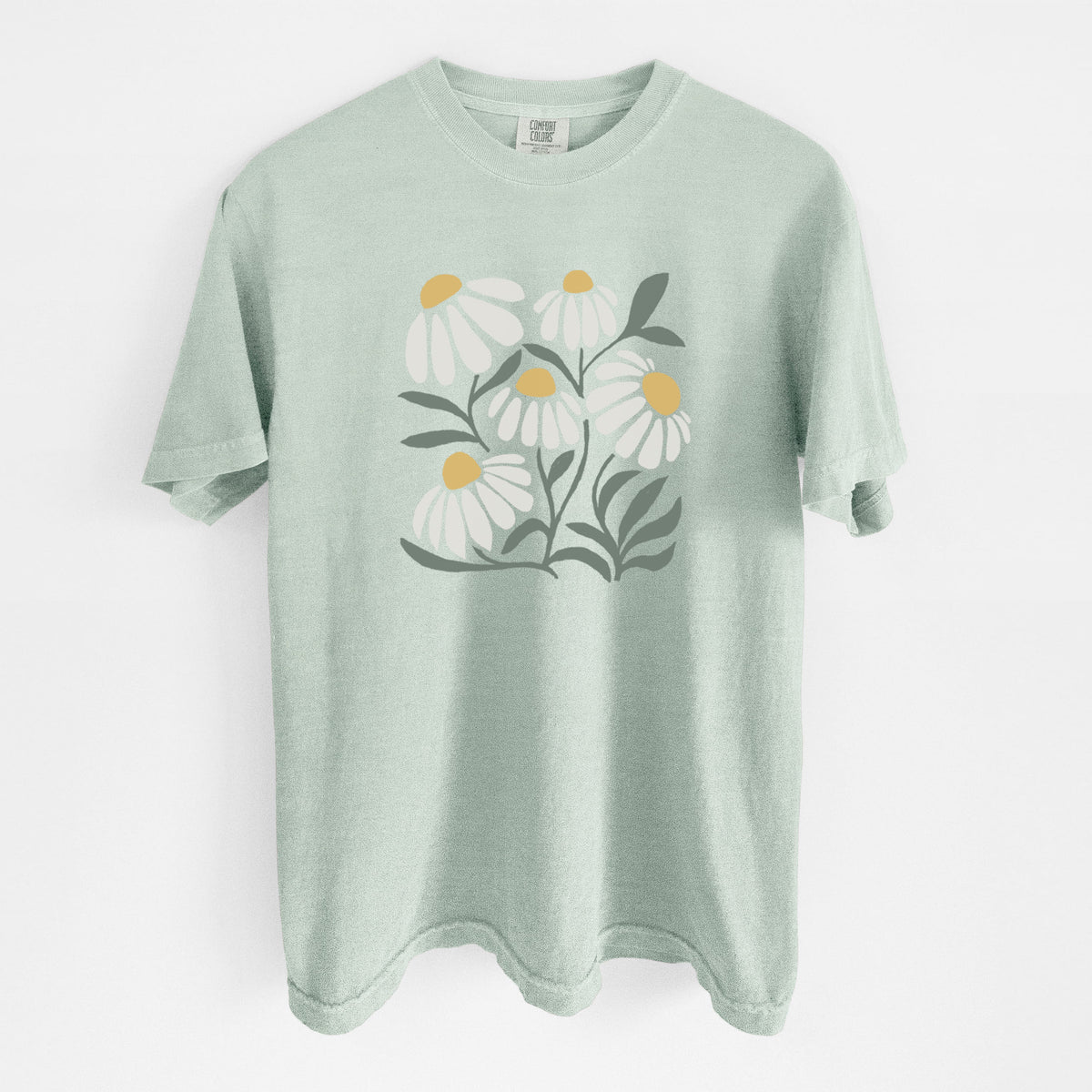 Bay green Comfort Colors t-shirt laid flat, printed with a soft full-color illustration of white chamomile flowers and green leaves.