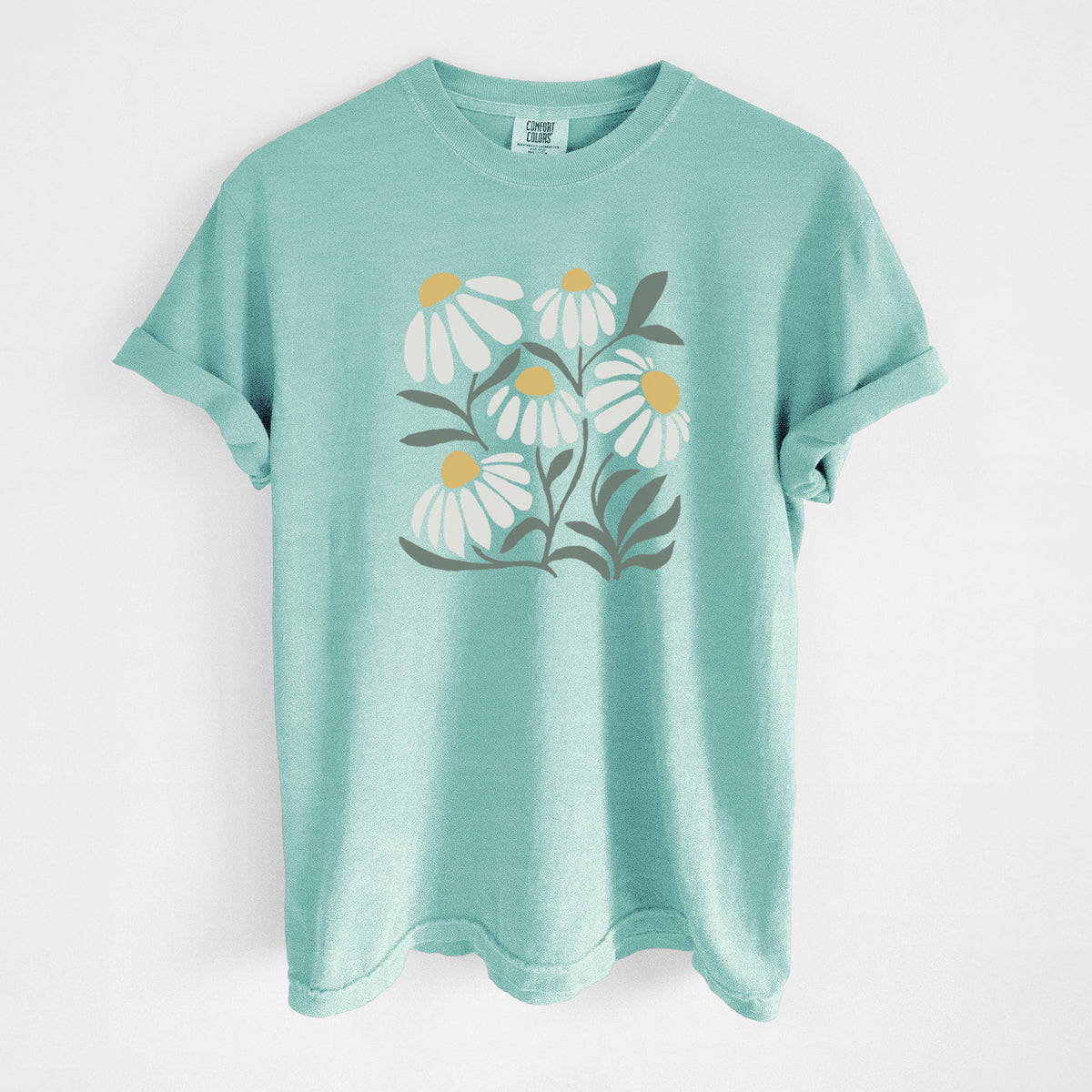 Chalky mint Comfort Colors t-shirt laid flat, printed with a soft full-color illustration of white chamomile flowers and green leaves.