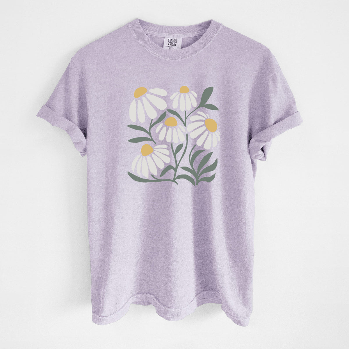 Orchid purple Comfort Colors t-shirt laid flat, printed with a soft full-color illustration of white chamomile flowers and green leaves.