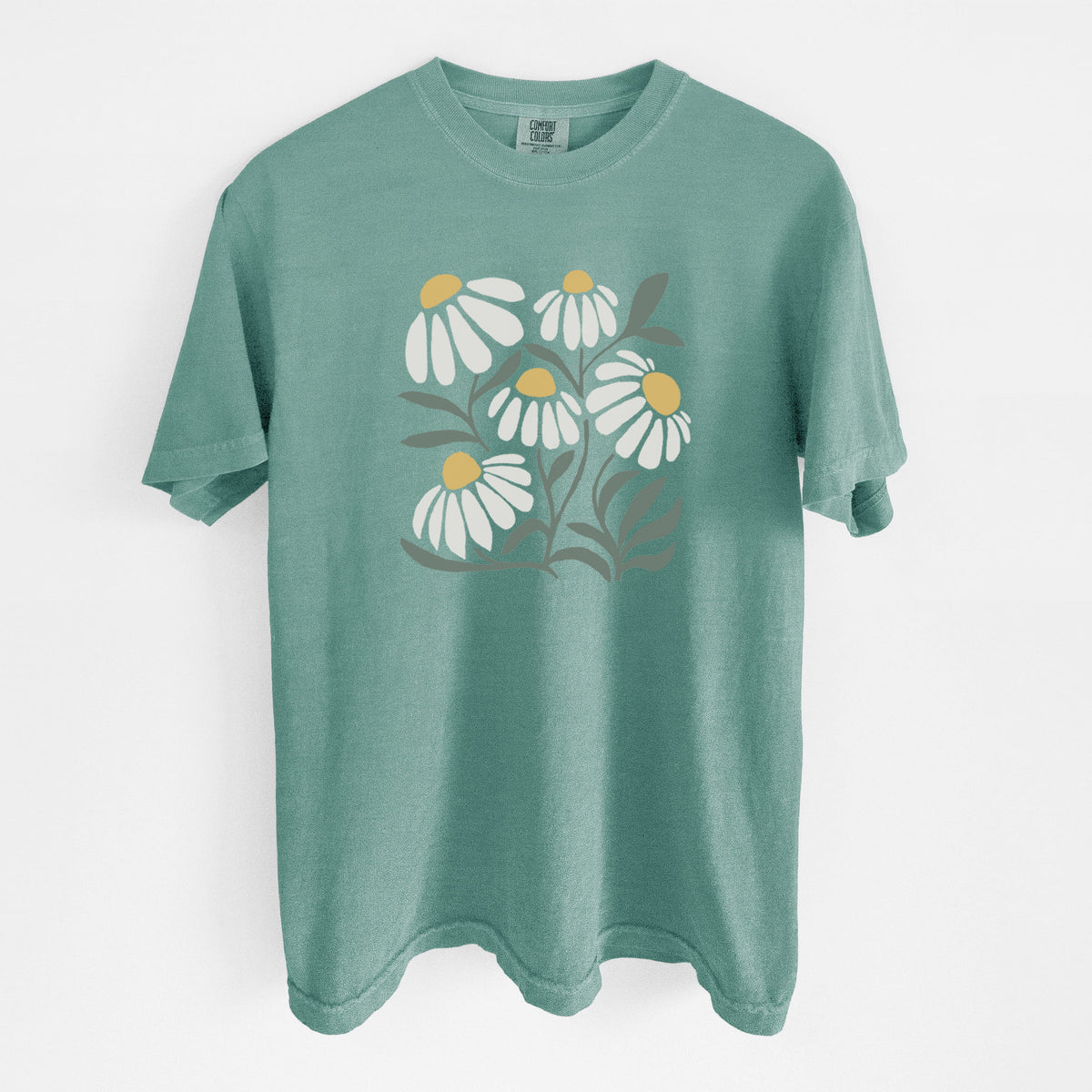 Reef green Comfort Colors t-shirt laid flat, printed with a soft full-color illustration of white chamomile flowers and green leaves.