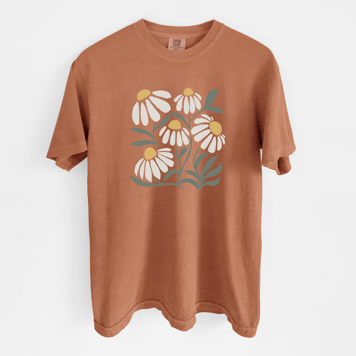 Yam burnt orange Comfort Colors t-shirt laid flat, printed with a soft full-color illustration of white chamomile flowers and green leaves.