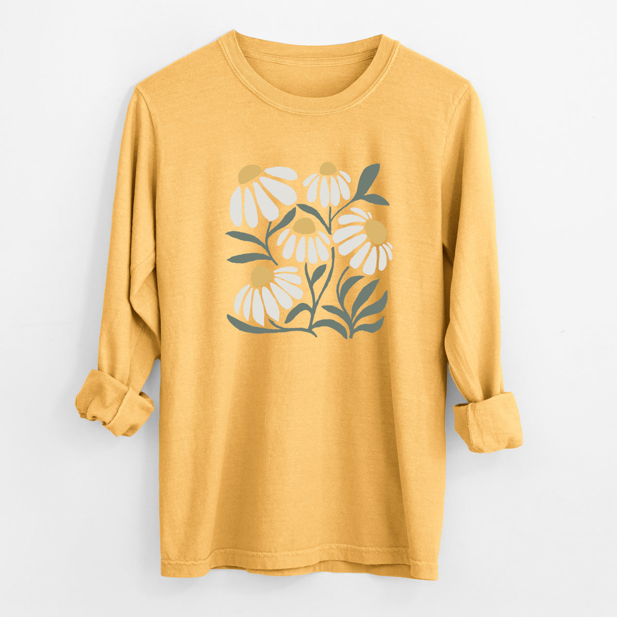 Golden wheat yellow Comfort Colors long sleeve shirt laid flat with the cuffs rolled, printed with a soft full-color illustration of white chamomile flowers and green leaves.