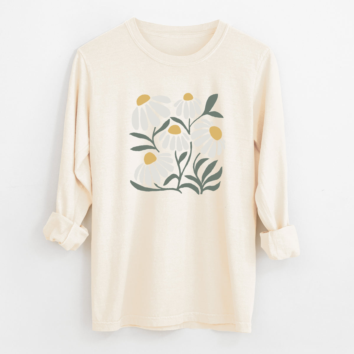 Ivory Comfort Colors long sleeve shirt laid flat with the cuffs rolled, printed with a soft full-color illustration of white chamomile flowers and green leaves.