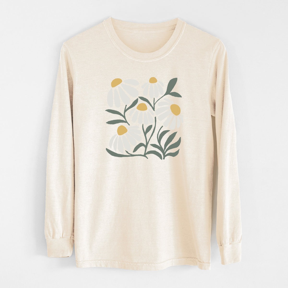 Ivory Comfort Colors long sleeve shirt laid flat, printed with a soft full-color illustration of white chamomile flowers and green leaves.
