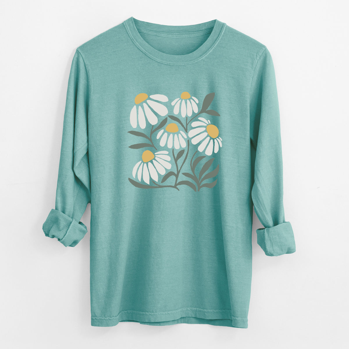 Reef green Comfort Colors long sleeve shirt laid flat with the cuffs rolled, printed with a soft full-color illustration of white chamomile flowers and green leaves.