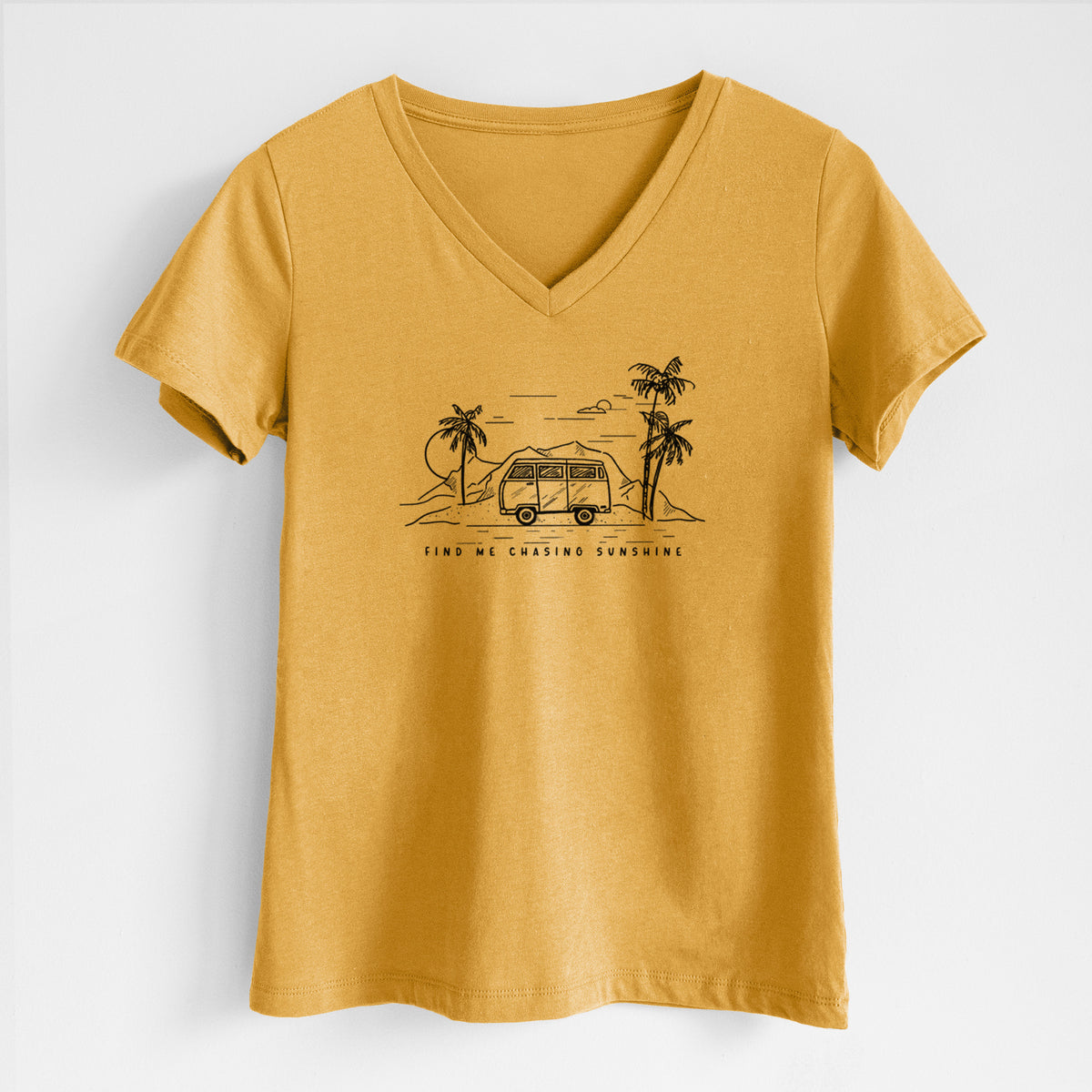 Honeycomb yellow women's relaxed fit cotton V-neck t-shirt laid flat, printed with a black ink illustration of a camper van under palm trees and the sun, with the words Find Me Chasing Sunshine.