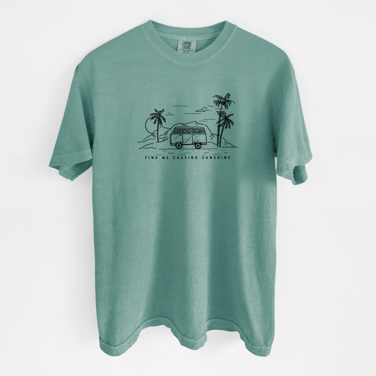 Reef green Comfort Colors t-shirt laid flat, printed with a black ink illustration of a camper van under palm trees and the sun, with the words Find Me Chasing Sunshine.