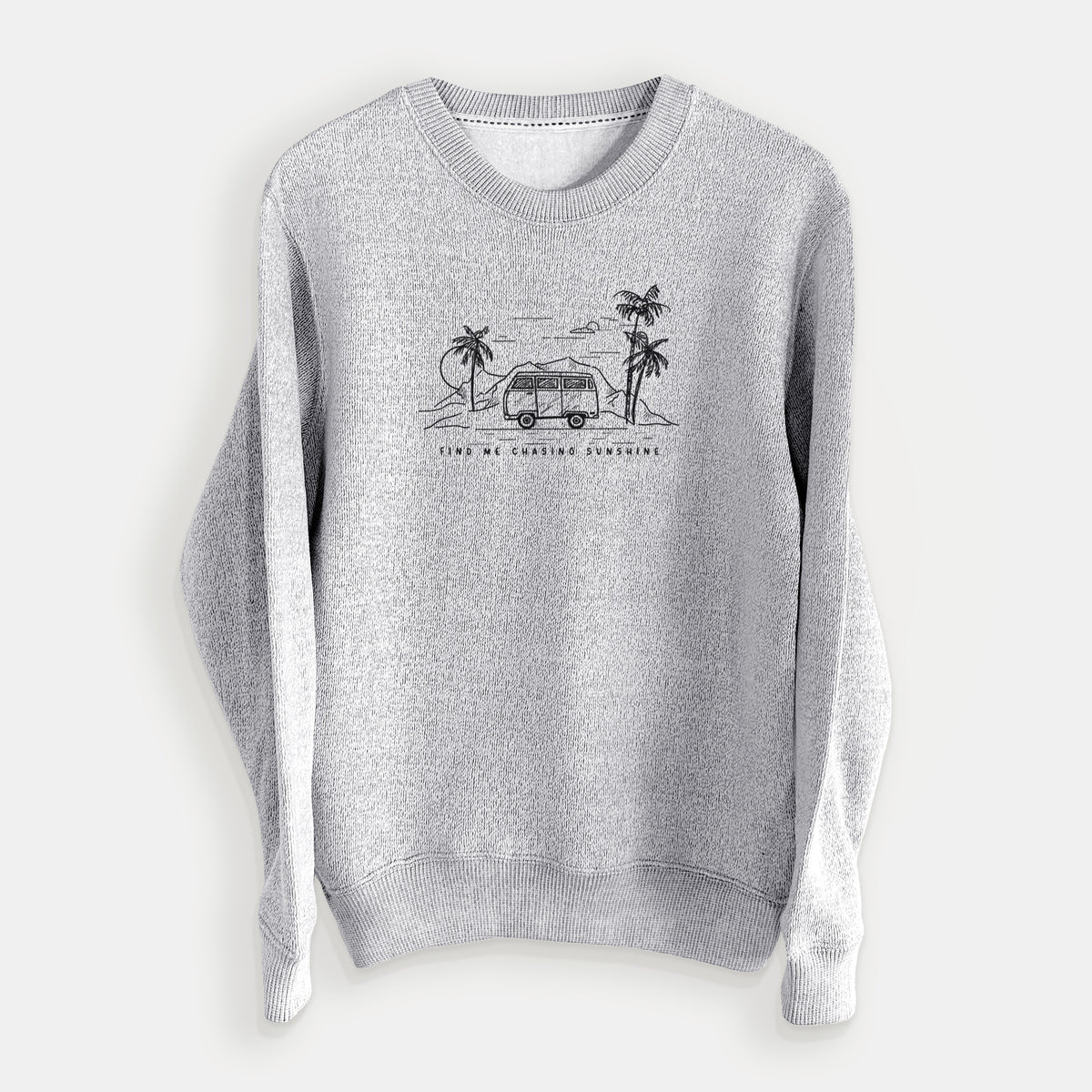 Salt and pepper knit sweatshirt laid flat, printed with a black ink illustration of a camper van under palm trees and the sun, with the words Find Me Chasing Sunshine.