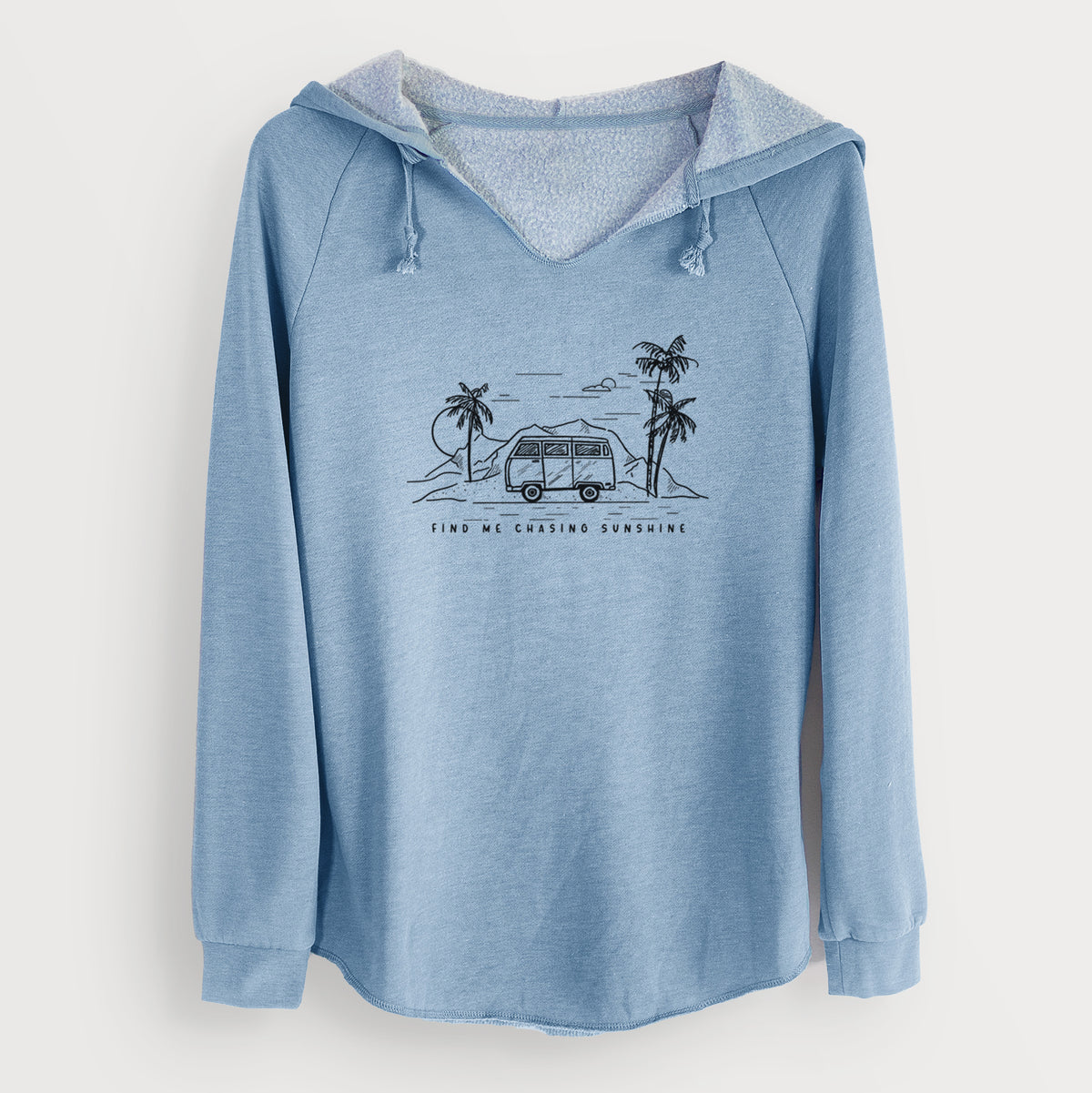 Misty blue women's Cali Wave hooded sweatshirt laid flat, printed with a black ink illustration of a camper van under palm trees and the sun, with the words Find Me Chasing Sunshine.