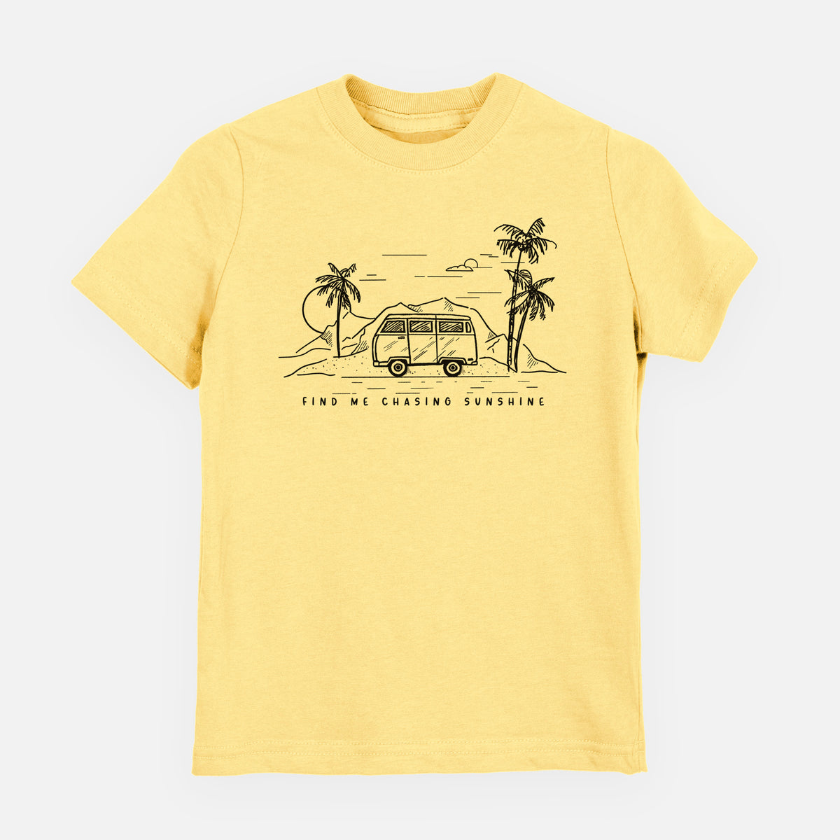 Butter yellow youth t-shirt laid flat, printed with a black ink illustration of a camper van under palm trees and the sun, with the words Find Me Chasing Sunshine.