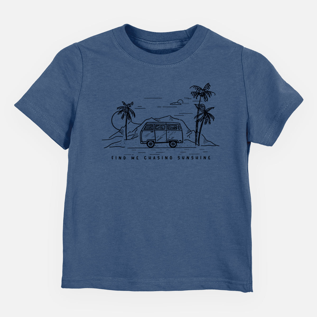 Indigo blue toddler t-shirt laid flat, printed with a black ink illustration of a camper van under palm trees and the sun, with the words Find Me Chasing Sunshine.
