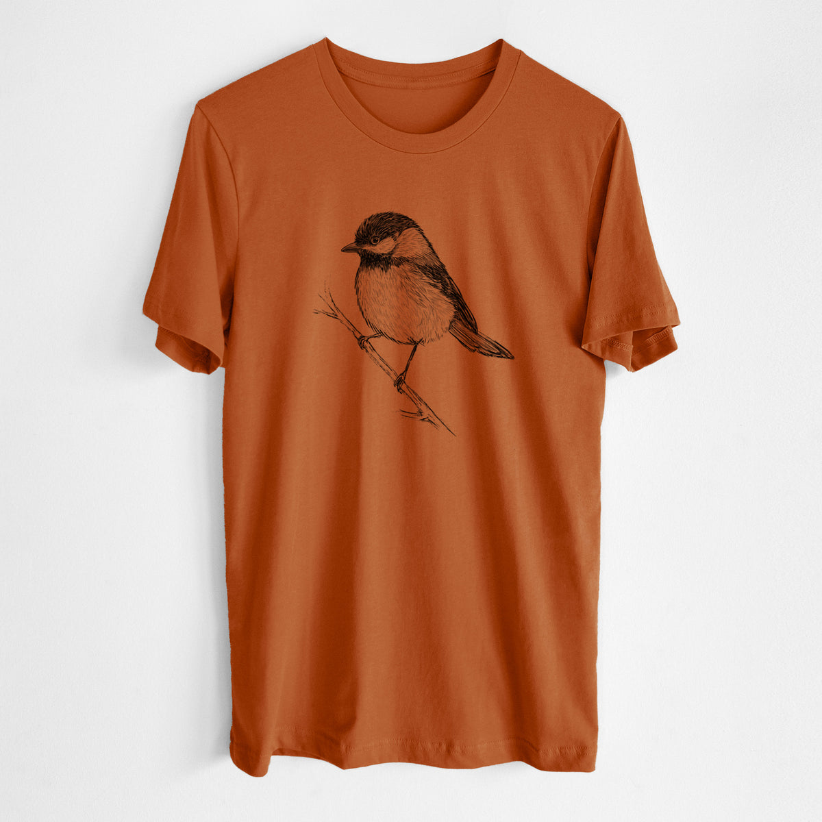 Autumn lightweight cotton t-shirt laid flat, printed with a detailed black ink sketch of a black-capped chickadee perched on a branch.