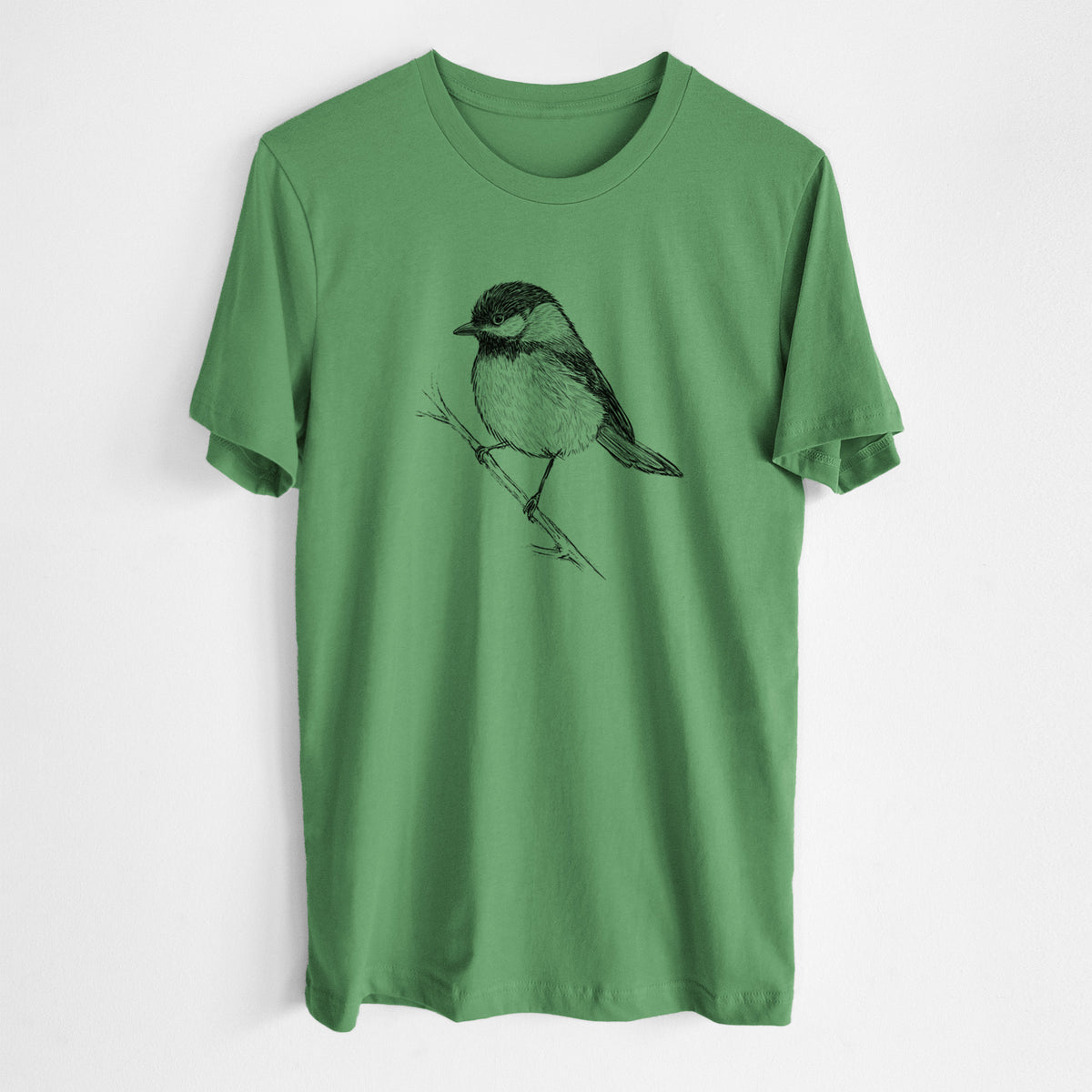 Leaf green lightweight cotton t-shirt laid flat, printed with a detailed black ink sketch of a black-capped chickadee perched on a branch.